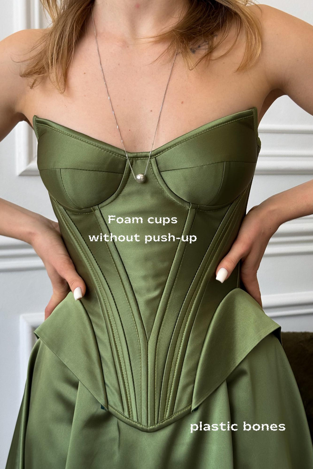 a woman in a green dress is holding her dress