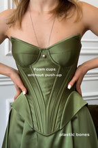 a woman in a green dress is holding her dress